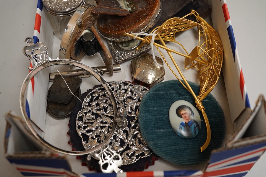 A collection of sundry silver items to include a silver mounted timepiece, hexagonal pill box and photo frames, one housing a hand painted porcelain portrait plaque, largest 12cm high